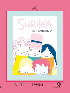 Capa do livro Suriléa, avó-monstrinha, com fundo rosa-escuro e moldura azul-clara simulando um quadro pendurado. No centro, a ilustração mostra seis personagens sorridentes, reunidos em um retrato de família: Suriléa aparece ao centro, usando cabelo rosa claro adornado com faixa azul, cercada por crianças com cabelos coloridos — rosa, loiro, azul e laranja. No canto inferior direito, aparece um gatinho amarelo com expressão curiosa. O título está no topo, com “Suriléa” em rosa-claro e “avó-monstrinha” em letras pretas desenhadas à mão. Na parte inferior, os nomes das autoras Lia Zatz e Rosinha, além do logotipo da Editora Peirópolis.